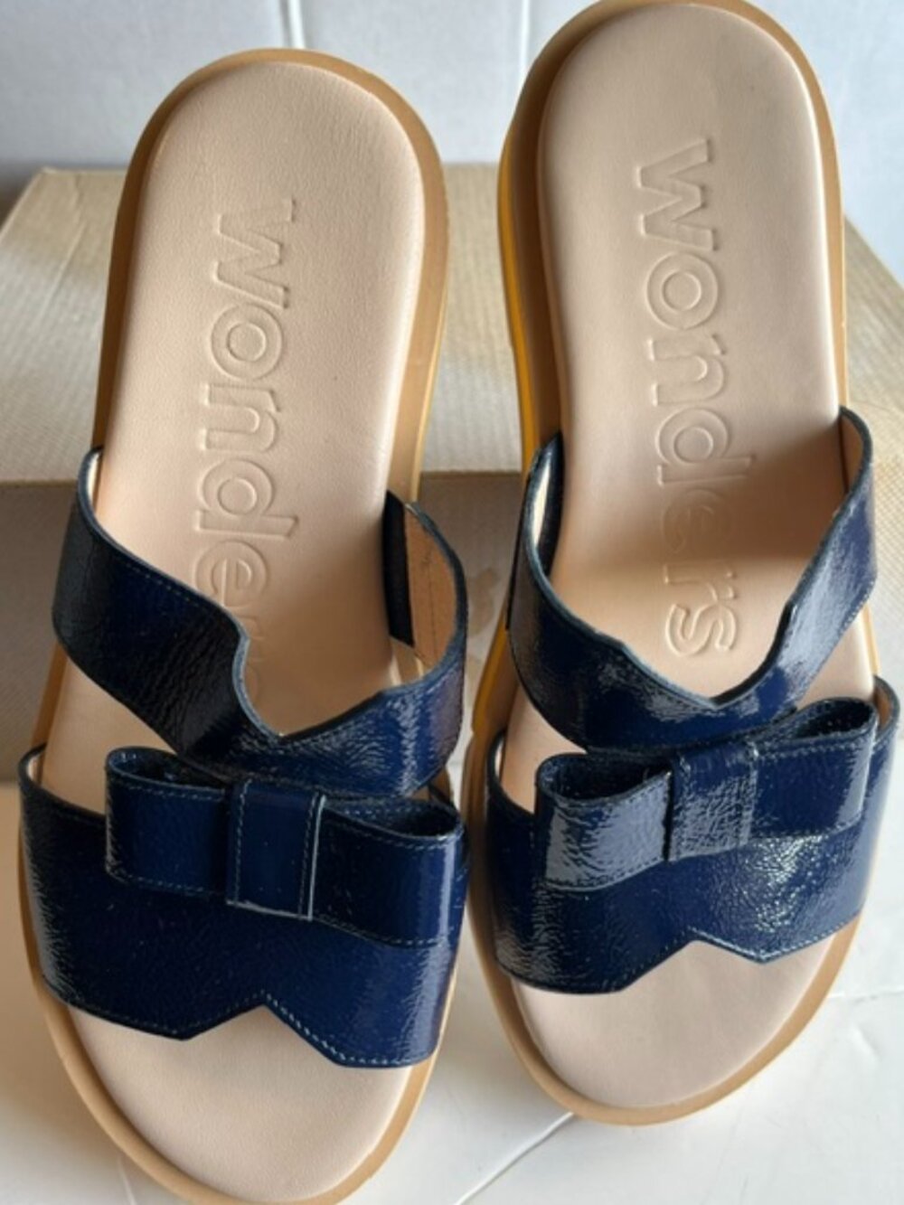 Wonders navy patent leather slides.